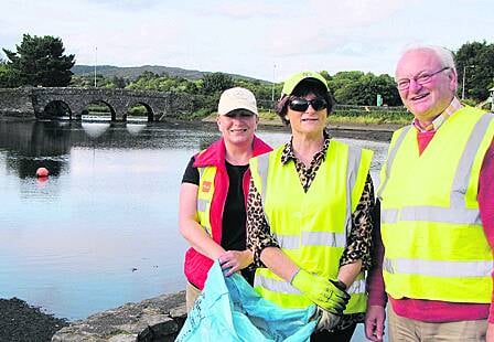 Tidy Towns volunteers Lorraine Swanton, Ann Redmond and John Forde taking part in one of the Wednesday evening clean-ups in  Ballydehob.                                                                                                                       