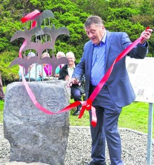 Actor Pascal Scott, top, cuts the tape on the Catalpa sculpture 