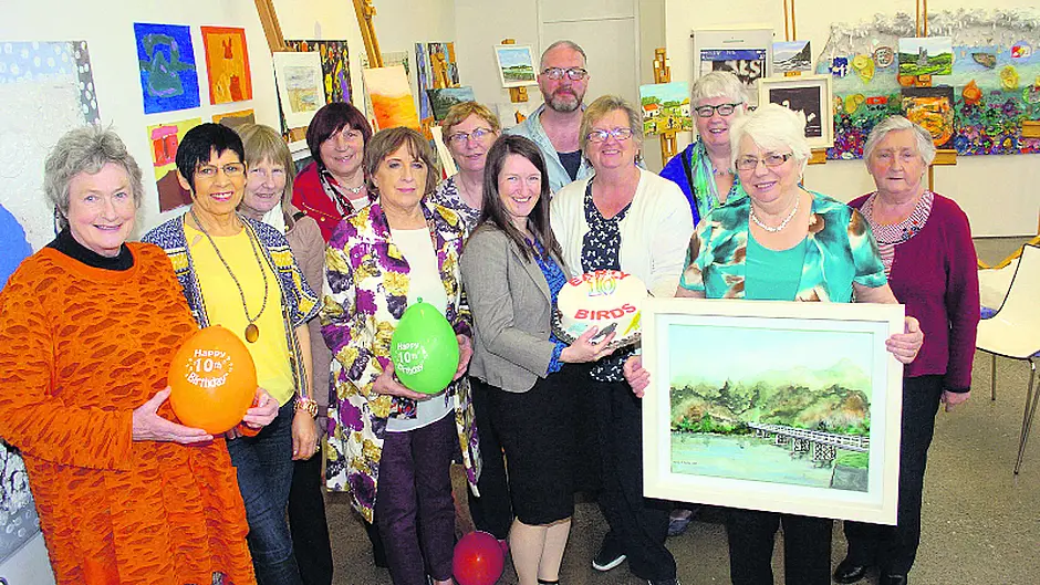 Group celebrating ten years of fun, friendship and art appreciation Image