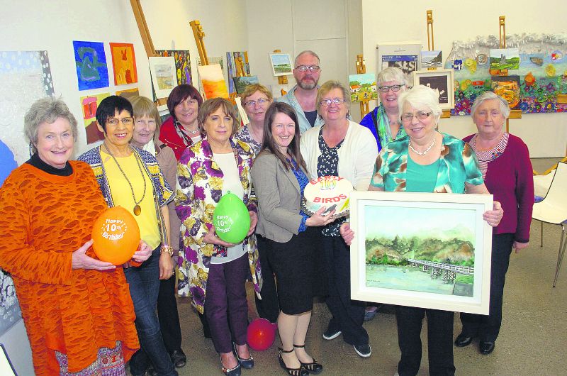 Group celebrating ten years of fun, friendship and art appreciation Image