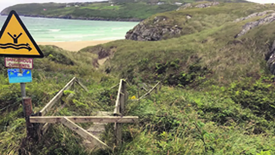 Dispute over beach access sees barbed wire coming and going Image