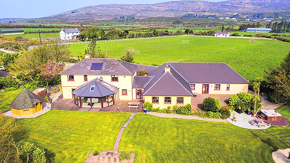 Lodge your interest in Schull home with a log cabin sauna and hot tub Image