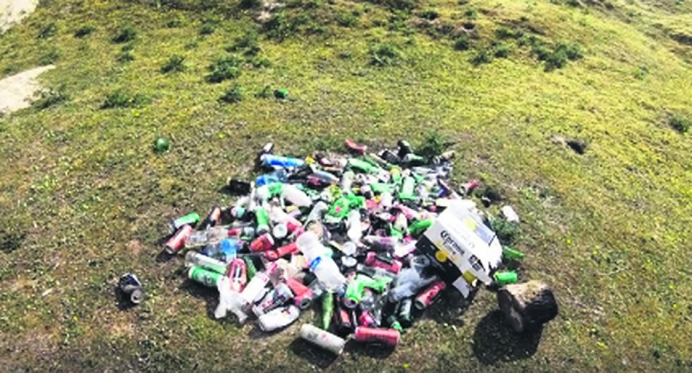 Beer bottles and cans left behind at two popular beaches Image