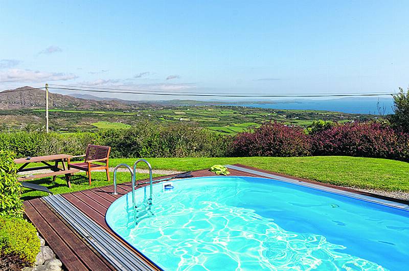 Soak up views in outdoor heated swimming pool Image