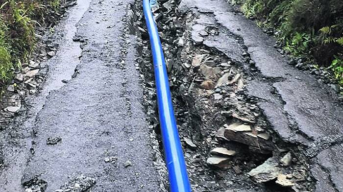 Downpour rips up repaired road Image