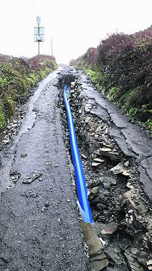 Downpour rips up repaired road Image