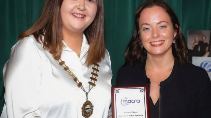 Macra national president Elaine Houlihan presenting Clonakilty Macra member Anne Barrett with her award after she won the national final of impromptu public speaking in Ennis on topics of pollution, streaming, and sustainability.