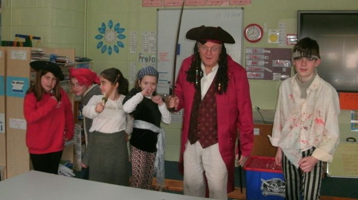 Pirates Tirna Horgan Maloney, Freya Horgan, Grace Solomon, Sarah Dukelow and Trevor Dukelow with their Captain Anthony Galvin at St James' National School.