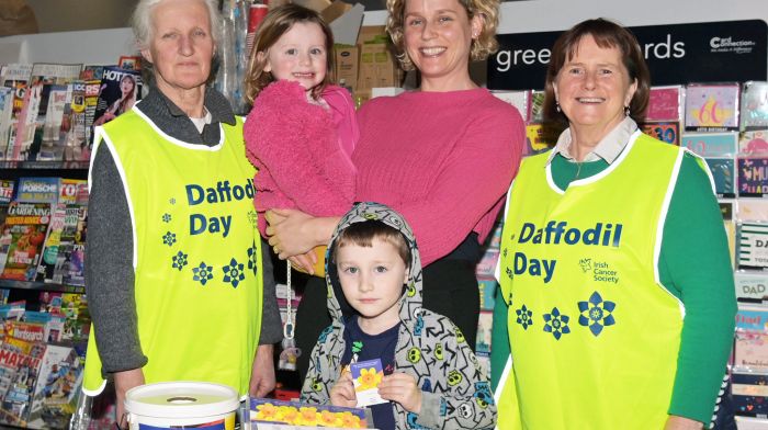 Daffodil Day volunteers Lola O’Regan (left) and Ann Murphy with Eilish Farrell, Butlerstown and her children Ann and Brendan at the EuroSpar Supermarket in Barryroe Co-op.  (Photo: Martin Walsh)