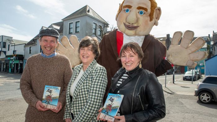 Author Barry Moloney with Angela Shanahan from Kinsale Tourist Office and illustrator Fiona Boniwell with the Kinsale Giant at the launch of Kinsale Stories an illustrated children’s history of Kinsale.   (Photo: John Allen)