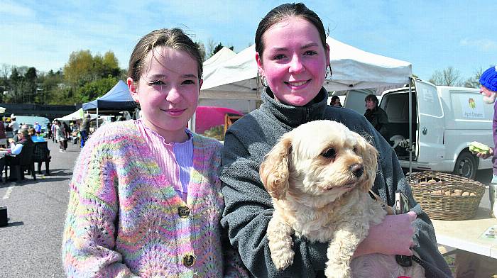 Sisters Eve Marie and Grace Gallagher with Trixie the dog enjoying the gorgeous sunshine at Skibbereen Farmers Market last Saturday. (Photo: Anne Minihane)