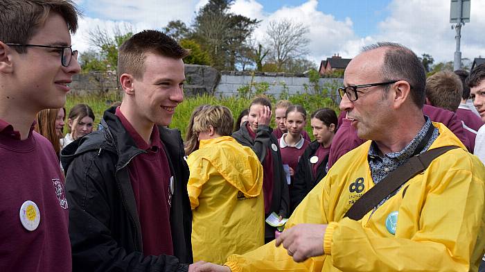 Schull Community College students Odhran Ó Treasaigh and Cathal Smith chatting with author Alan Nolan who was part of the Laureate na nÓg Whole Wild World bus tour that visited the college on Friday.