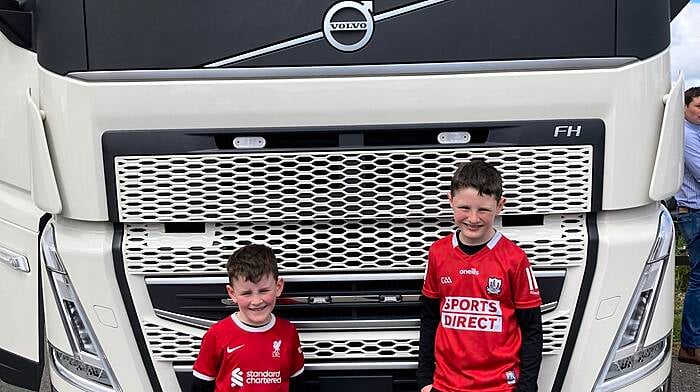 Don Coomey's lorry preparing to lead the tractor run which was held in aid of Clogagh National School with pupils Conor and Jack O'Sullivan standing to attention.