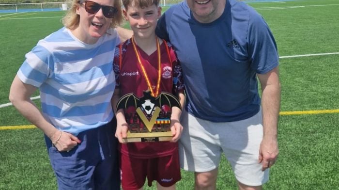 Charlie Moore with his parents Maurice and Elaine after Charlie won the Valencia MIE cup in Valencia with the Cobh Ramblers Academy.
