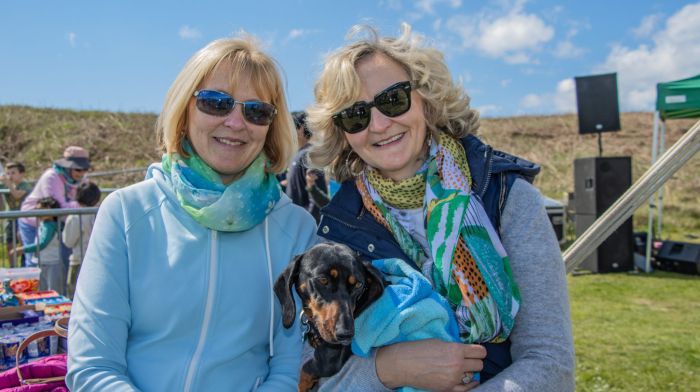 “Lucky’s Day Out,” (L to R), Miriam Troy and Deirdre O’Brien and her dog, “Lucky,” enjoying the sunshine and entertainment at the Fish Basket Long Strand Tractor & Truck Run in aid of Critical and West Cork Underwater Search & Rescue.