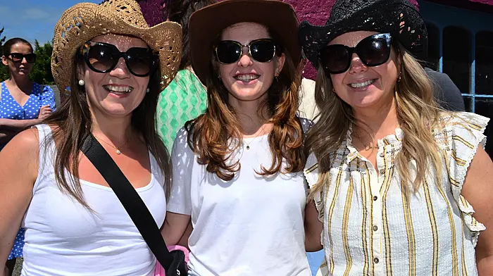 Aine Long from Cork with Ballydehob ladies Eimear and Ciara O'Regan soaking in the sunshine at the Ballydehob Country Music Festival which was held last weekend. (Photo: Anne Minihane)