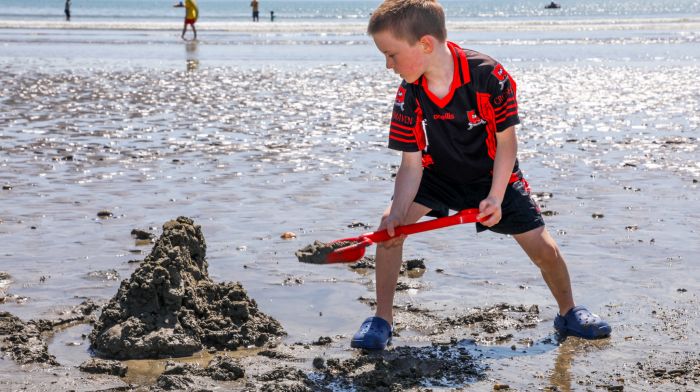 Fountainstown, Cork, Ireland. 23rd June, 2023. Pearse Murphy (7) from Hoddersfield building a sandcastle on Fountainstown beach, Co. Cork.  - Picture: David Creedon