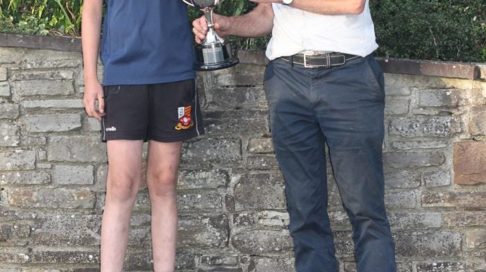 Brian Harrington from Dromourneen, Bantry, receiving the Carbery Oil Cup from Frank Hurley, after winning the Carbery U12 championship.