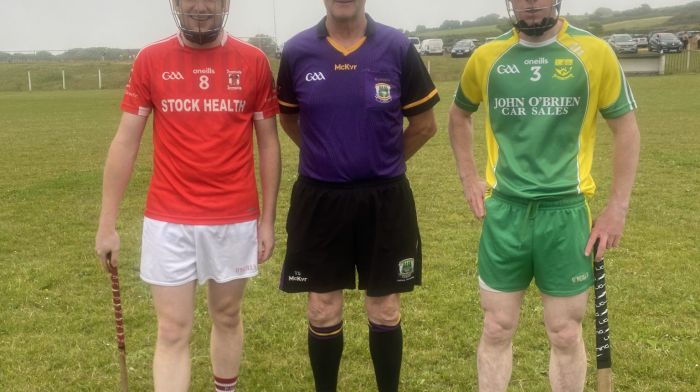 Ballinascarthy captain David Walsh with referee T Sheehan and St James' captain Eoin Deasy.