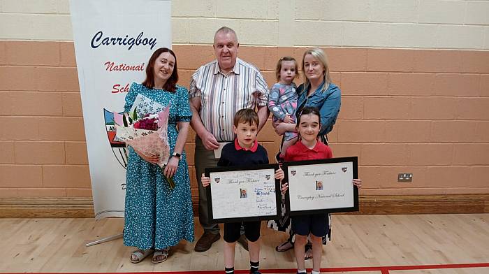 Finbarr O'Sullivan with his daughters Mandy (left) and Orla and grandchildren Páraic, Hanna and Aedín at the Carrigboy National School awards day when presentations were made to him to mark his retirement as chairperson of the board of management, a position he had held for 18 years.