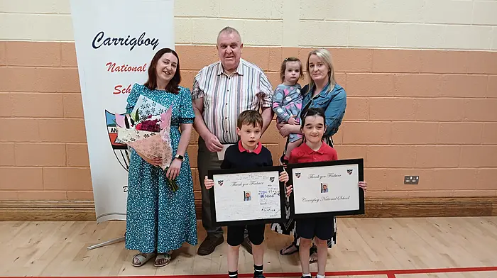 Finbarr O'Sullivan with his daughters Mandy (left) and Orla and grandchildren Páraic, Hanna and Aedín at the Carrigboy National School awards day when presentations were made to him to mark his retirement as chairperson of the board of management, a position he had held for 18 years.