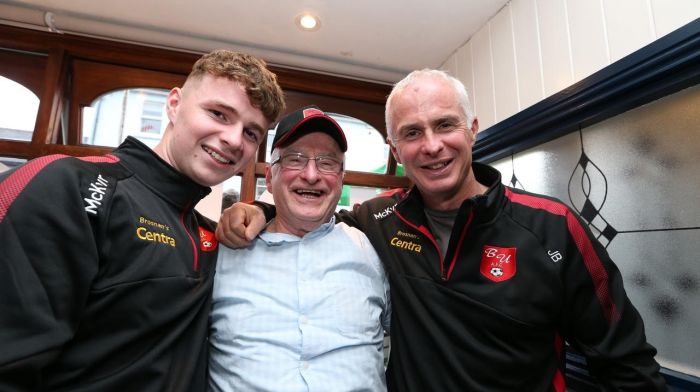 Tom Brosnan flanked by his grandson Conor and son Jeremy, as three generations of the Brosnan family enjoy a night off from the Centra and join in the Bunratty celebrations.  (Photo: Carlos Benlayo)