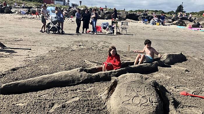 Johanna and James from Owenahicha with the Olympic double skull they built during the sandcastle competition which was held on the Warren strand, Rosscarbery.