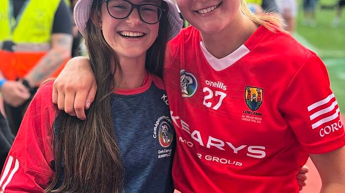 Karen O'Sullivan with her older sister Ciara, who won an All-Ireland camogie medal last Sunday in Croke Park after Cork defeated Galway.