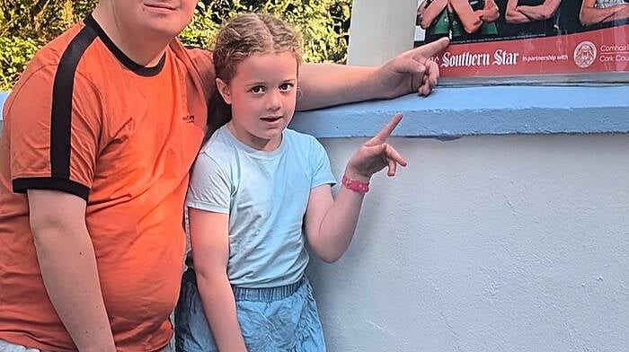 The Southern Star’s poster for the Olympics outside Noreen Desmond’s house being admired by Ronan Desmond from Templemartin and his niece Mary Kate Cassidy.