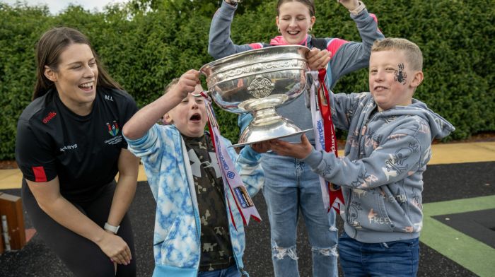 Molly Lynch, All-Ireland winning camogie captain with Liam, Tadhg and Isobel Kelly from Dublin Pike at the Crann Centre in Ovens where families enjoyed a fun day of activities.  (Photo: Brian Lougheed)