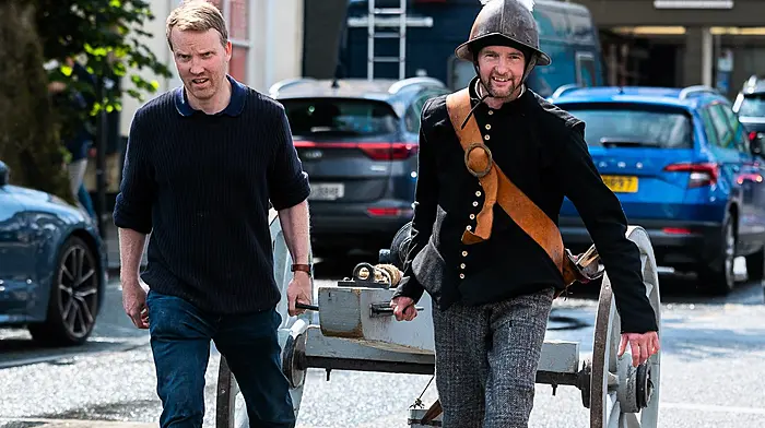 Historian Fergal Phillips from the Kinsale Cultural & Heritage Society and ‘Spanish artillery officer’ Ros Keddy from the Lord Edwards Own re-enactment society, pulling a cannon through Kinsale for a living history display showcasing clothing, weapons, and drills from the Battle of Kinsale as part of the 424th anniversary event for the battle. (Photo: John Allen)