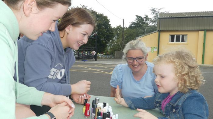 Nail artists Abbie and Amy Sheehan with Noelle Carey and little Grace Carey, carefully choosing her favourite colour – yellow - for her nails at the Gaggin summer barbecue.