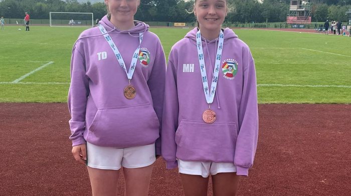 Tara Duggan and Maggie Hallihane with the Skibbereen Community Games U14 football team who finished third in the Cairn Community Games All-Ireland series.