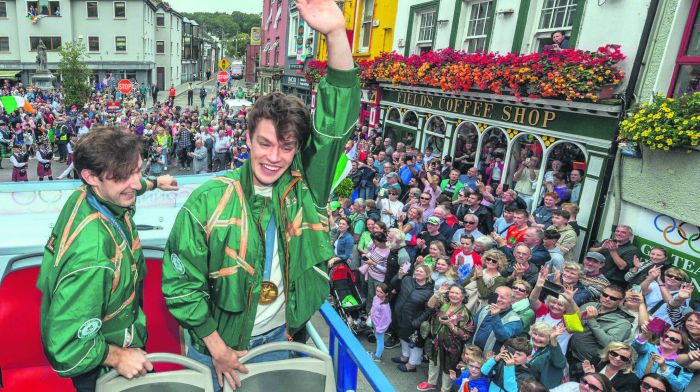 Paul O’Donovan and Fintan McCarthy wave to the crowds on the streets of Skibbereen for the homecoming parade. (Photo: Andy Gibson)