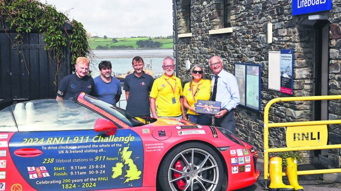 London couple James and Belinda Richardson with their Porsche 911 in Courtmacsherry
with the RNLB Val Adnams in the background as they continue their fundraising tour visiting
all 238 RNLI lifeboat stations across Ireland, Scotland, Wales and England.   ey were
welcomed by members of the Courtmacsherry Lifeboat (from left): Vincent O’Donovan
(PRO), Ken Cashman (coxswain), Stuart Russell (chief mechanic) and Brian O’Dwyer (lifeboat
operations manager). (Photo: Martin Walsh)