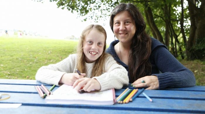 Jennifer Shore and her daughter Ella Shore Luftos (8) from Ballydehob enjoying colouring her book at the park on a visit to Schull. (Photo: Carlos Benlayo)