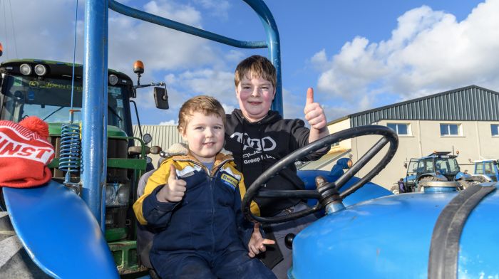 Adam Holland from Newcestown and Eoin Doolan from
Rosscarbery enjoying their day in the sunshine at the
Ahiohill tractor run. Proceeds of the run will go to Cancer
Connect, West Cork Rapid Response and Ahiohill National
School. (Photo: David Patterson)