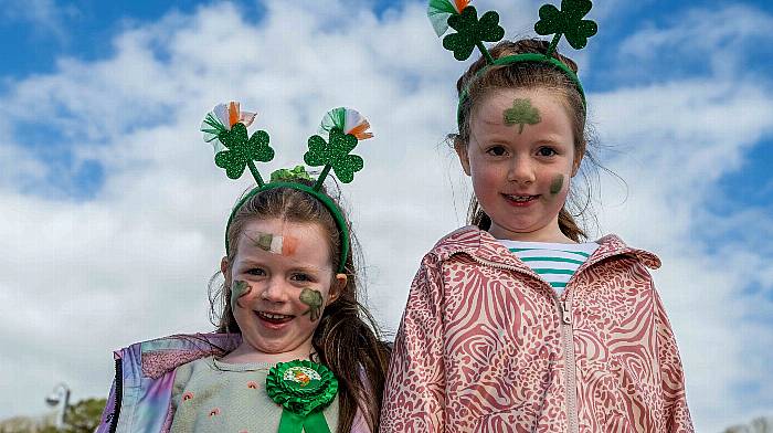 Bantry, West Cork, Ireland. 17th Mar, 2024. The sun shone today as the community came together for the Bantry St. Patrick's Day parade. Thousands of people from across Ireland were present to watch the parade. Suitably dressed for the day were Anna and Katie Stack, Bantry. Picture: Andy Gibson.