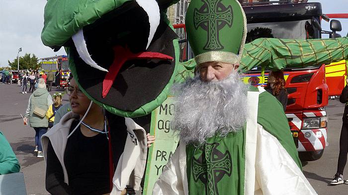 St Patrick aka Michael Brennan, chasing the snakes away at the St Patrick’s Day parade in Bandon.   (Photo: Denis Boyle)