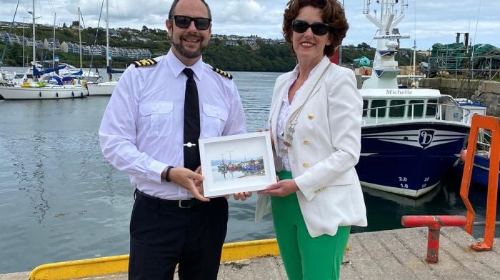 Cllr Gillian Coughlan, chair of Bandon Kinsale Municipal District greeting the captain of the Hebridean Princess, Magnus Davidson, and presenting him with a token to mark the occasion.