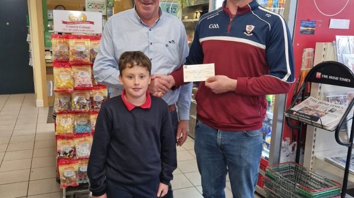 Fionn Doonan (junior captain of Muintir Bháire GAA) presenting Mackey O’Mahony (left) from Ballydehob with a cheque for €7,000 after he won the jackpot in the Muintir Bháire lotto. The presentation took place at The Village Grocer in Durrus where Mackey bought the winning ticket. Also included is Mackey's grandson Matthew O'Mahony, who plays with the Muintir Bháire U10 team.