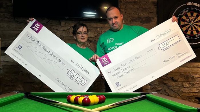 Valerie Hurley and Daniel O’Regan with cheques representing the money raised from the Mick Finns charity pool tournament which was held in aid of the Irish Motor Neurone Disease Association and the John Doherty family.