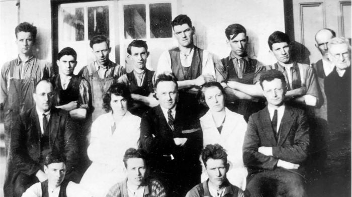 Barryroe Co-op staff photo from the 1930s. Standing: Sonny O’Donovan (fourth from left), Richard Fleming (sixth from left), Tommy Harte (seventh from left) and  Fr Jeremiah Burke (chairman) is on the extreme right.  Middle row: William John Barry (extreme left), Maurice Collins, general manager (centre), Mary Barry and Willie Finn. See notes for the request to help identify the others.