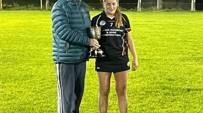 Danny Buckley, Carbery camogie development officer, presenting Grace Ahearne, Enniskeane captain, with the trophy.