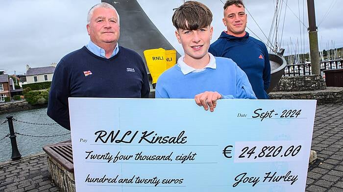 Kinsale teenager Joey Hurley raised €24,800 for the RNLI in memory of his beloved uncle, the popular local fisherman, Des Hurley. Joey, who undertook the gruelling ‘Duathlon for Des’  is pictured here presenting the cheque to John O’Mahony of Kinsale RNLI. Also included is Joey’s personal trainer Mikey Power.                               (Photo: John Allen)