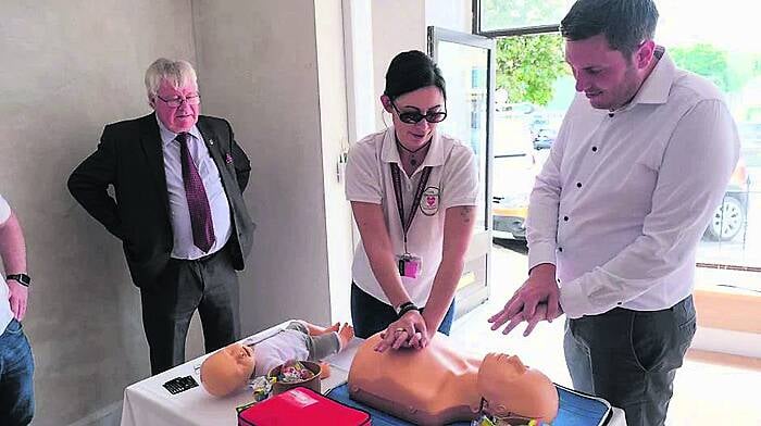 Hailed as a ‘vital asset’ that will save lives, a public defibrillator was launched in Dunmanway in July by County Mayor Joe Carroll. Yvonne Cahalane of CFR Dunmanway is seen here demonstrating lifesaving CPR techniques to Ind Ire Cllr Daniel Sexton and Cllr Carroll. (Photo: Flash Photography Studio)