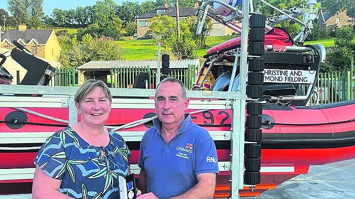 Mary Rose Deasy, Union Hall, receiving an award in recognition of her 20+ years of fundraising work in support of the RNLI from local lifeboat operations officer John Kelleher in August.