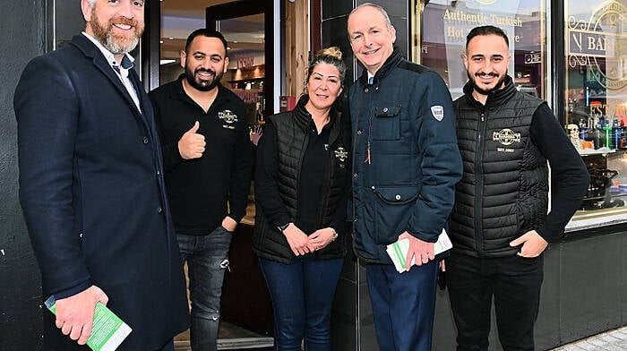 Staff of the Golden Scissors barbers in Bandon with Micheál Martin, Tánaiste, Minister for Foreign Affairs and Defence and Christopher O’Sullivan, TD in Bandon in October. (Photo: Martin Walsh)