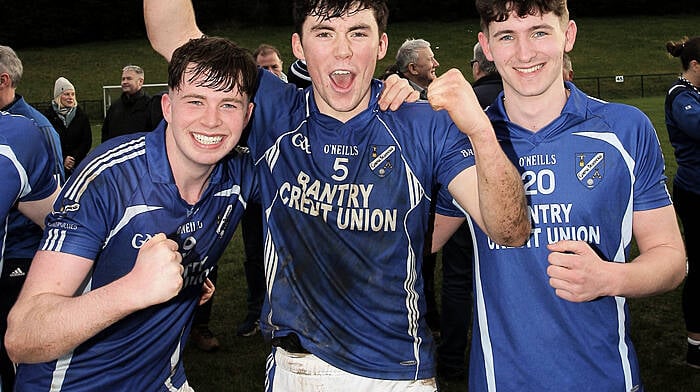 Bantry Blues captain Dara McCarthy with John Crowley and David Shiels Jnr after their victory over Ibane Gaels in the Carbery U21A Football Championship final in February.