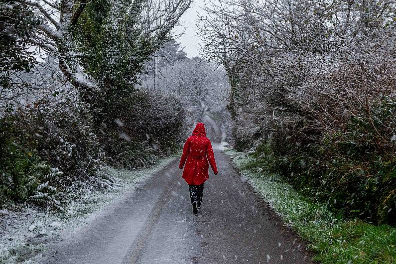 A woman walks as heavy snow falls in Connonagh this morning. (Photo: Andy Gibson)